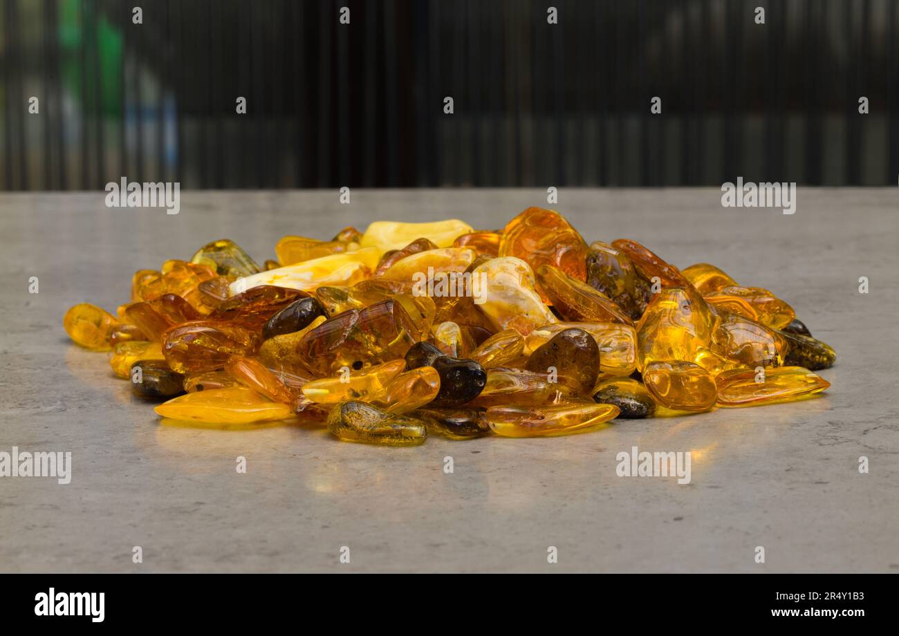 Natural, polished Baltic amber found on a beach in Kołobrzeg, Poland. Amber prepared for making pendants. Stock Photo