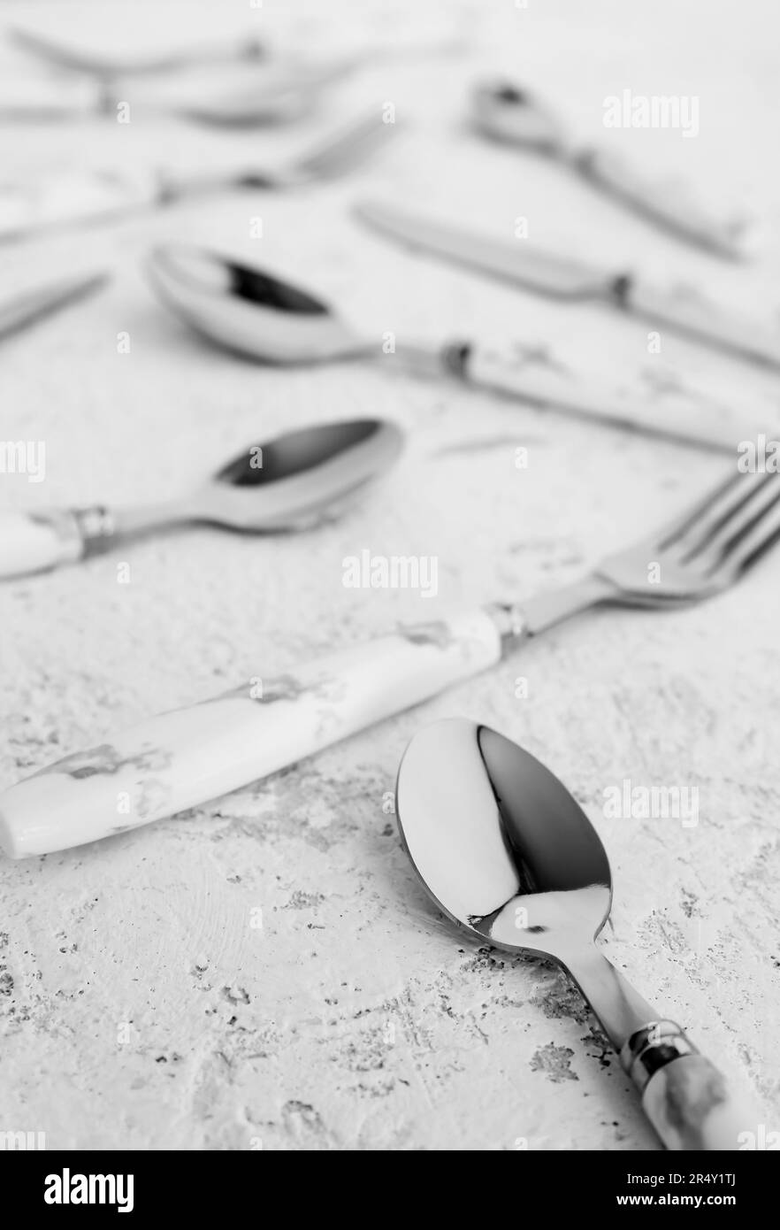 Stainless steel cutlery with plastic handles on white background Stock