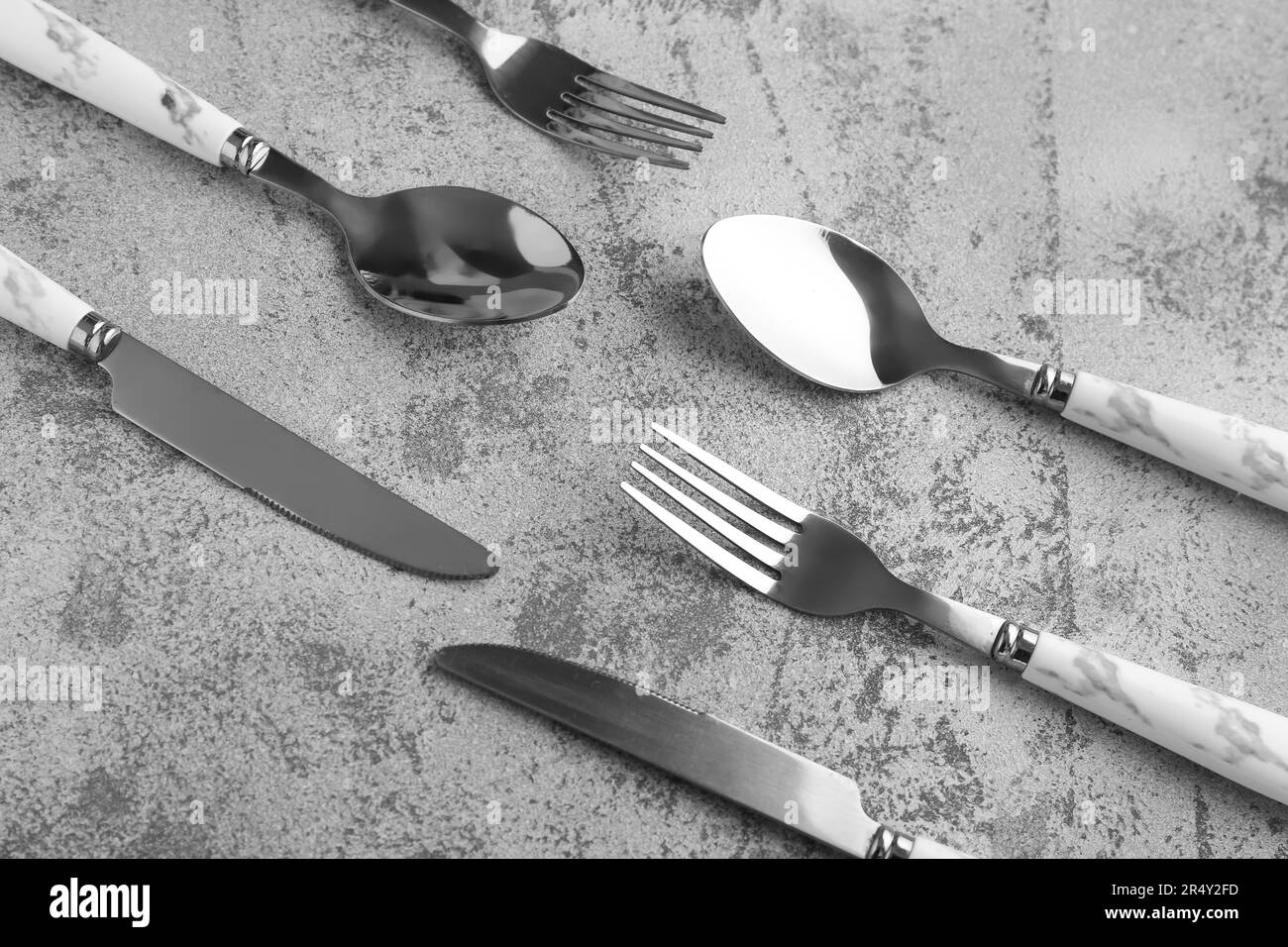 Silver cutlery on grey grunge background Stock Photo