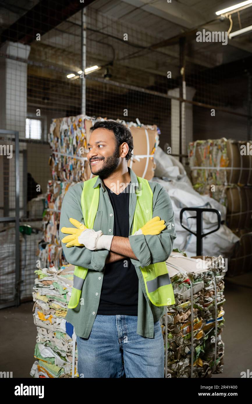 Positive indian sorter in protective gloves and vest crossing arms