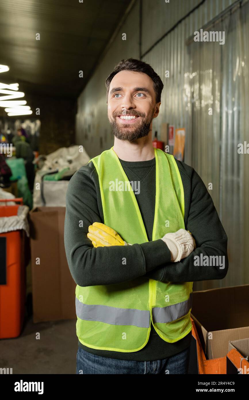 Positive male sorter in high visibility vest and protective gloves