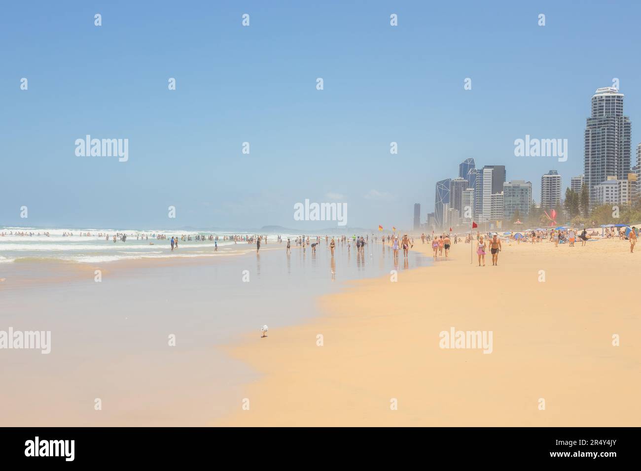Surfers Paradise, Australia - January 4, 2023: Tourists and surfers enjoy leisure holiday time at beach vacation destination, Surfers Paradise, Queens Stock Photo
