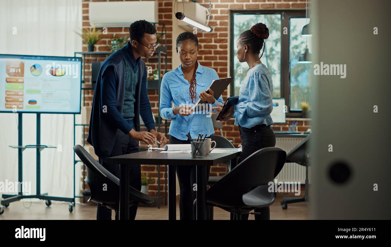 Business people reviewing paperwork Stock Photo - Alamy