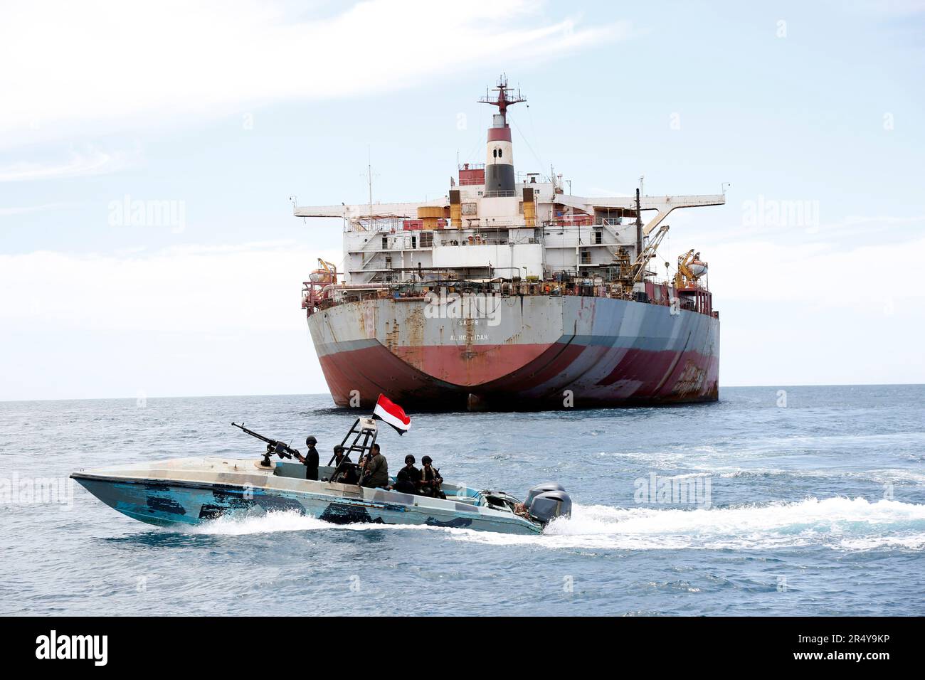 Hodeidah, Yemen. 30th May, 2023. A Yemen's coast guard boat sails past the FSO Safer vessel at Ras Issa port in Hodeidah province, Yemen, on May 30, 2023. A United Nations (UN) ship arrived on Tuesday at the site of the floating storage and offloading (FSO) Safer vessel, a decaying super oil tanker, off the coast of Ras Issa, Hodeidah in western Yemen. Credit: Mohammed Mohammed/Xinhua/Alamy Live News Stock Photo