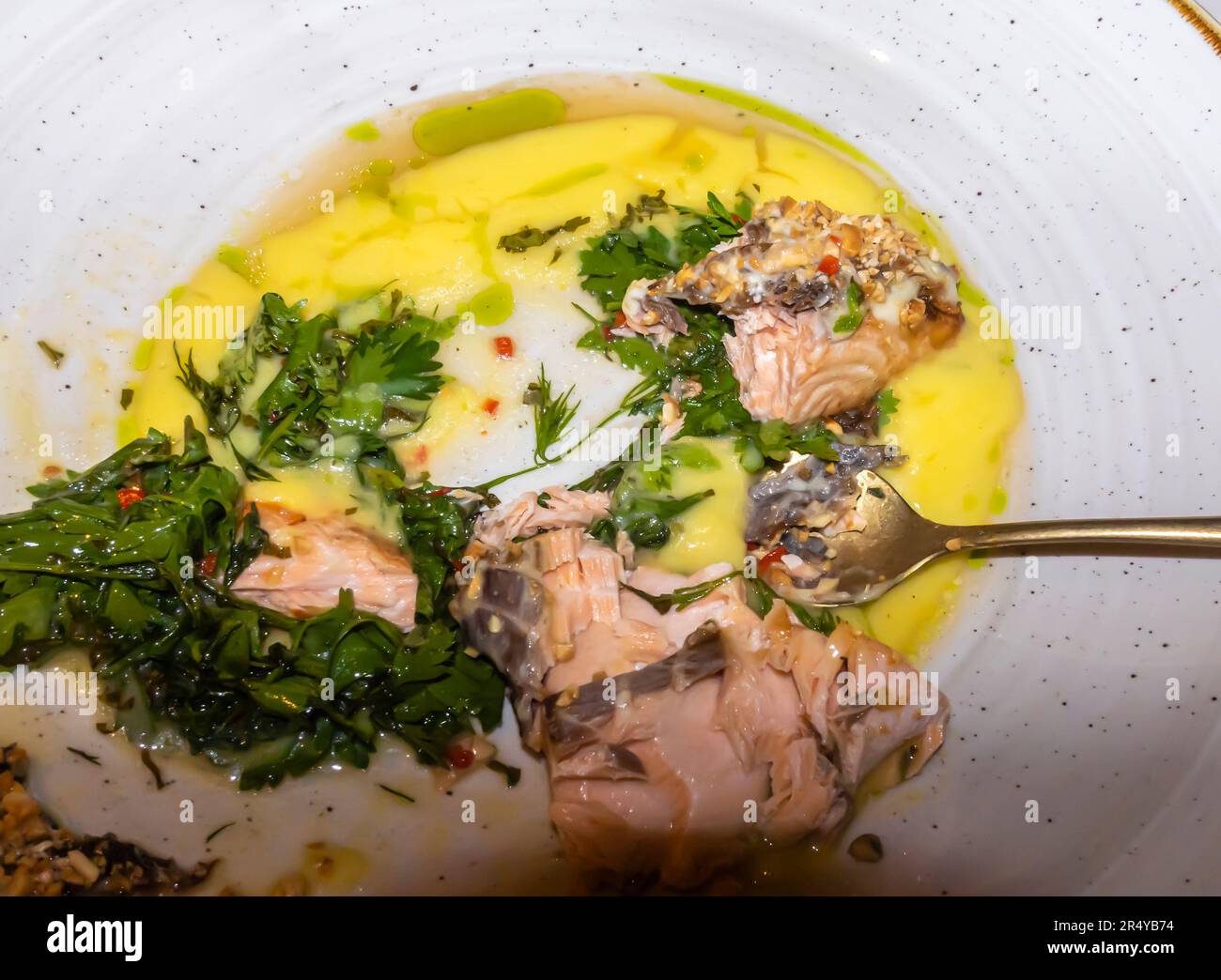 Seabass fish fillet on a plate, lemon, mediterranian salsa with grill