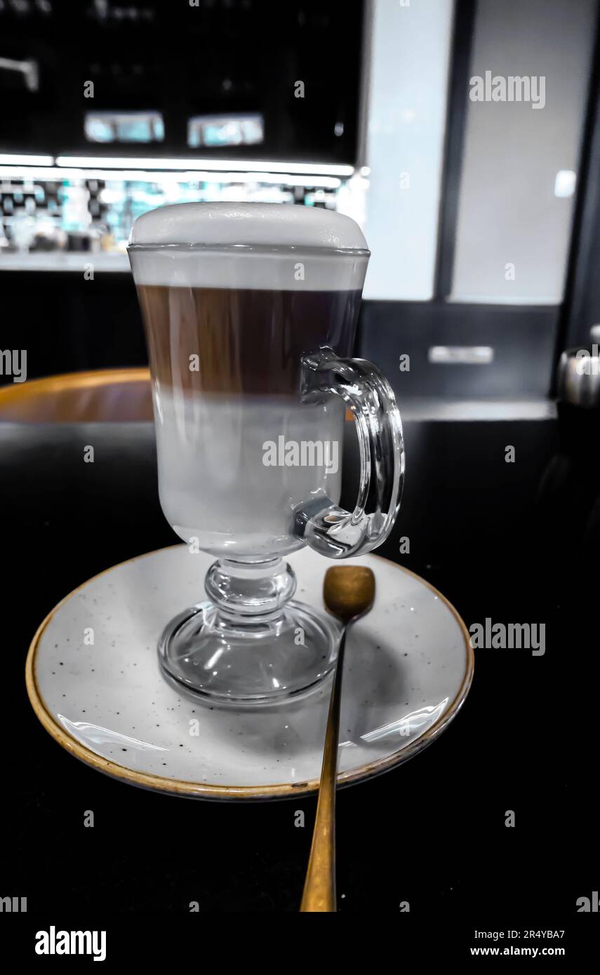 Irish coffee glass on a dark desk, dark background Stock Photo