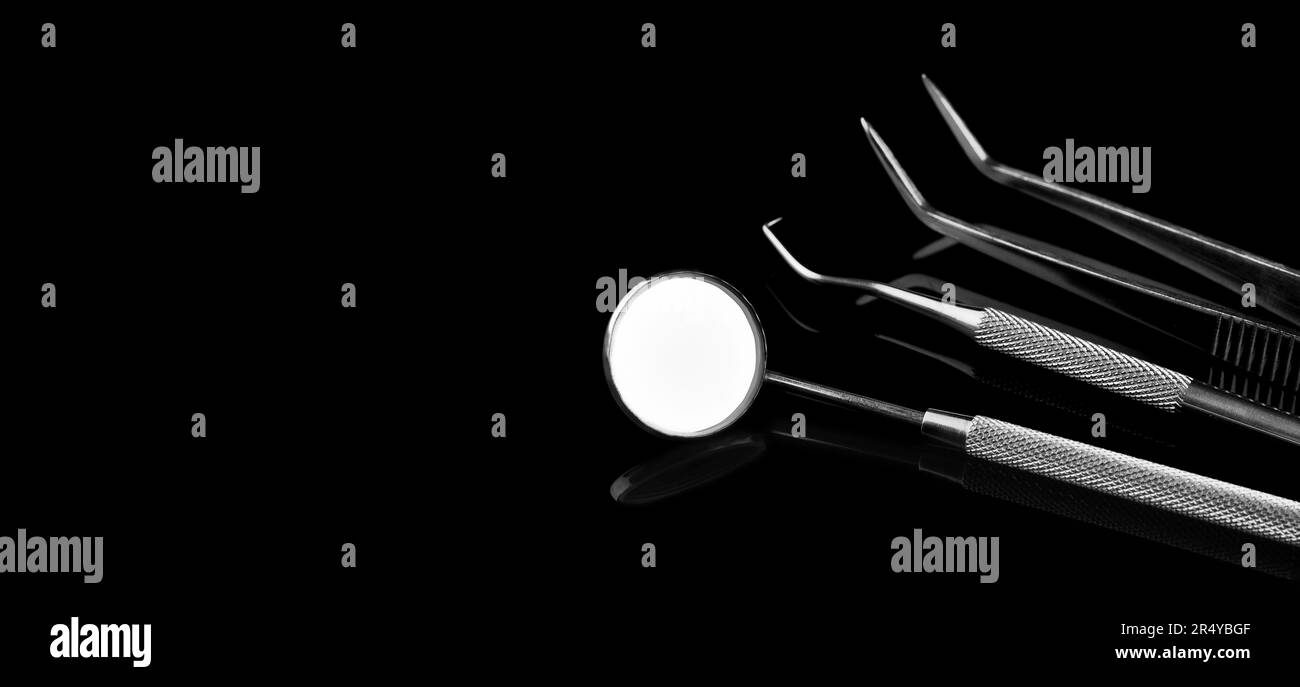 Basic dentist tools isolated on black. Dental tools on black shiny