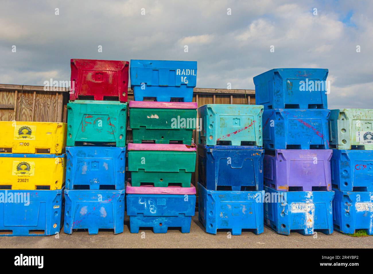 Colourful insulated fish containers stacked and ready for use Steveston British Columbia Canada Stock Photo