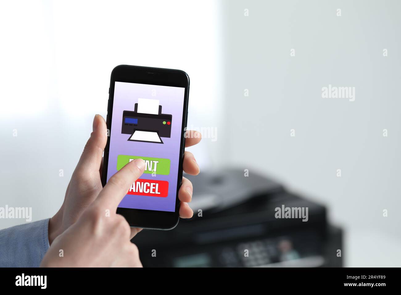 Man using printer management application on mobile phone indoors, closeup and space for text Stock Photo