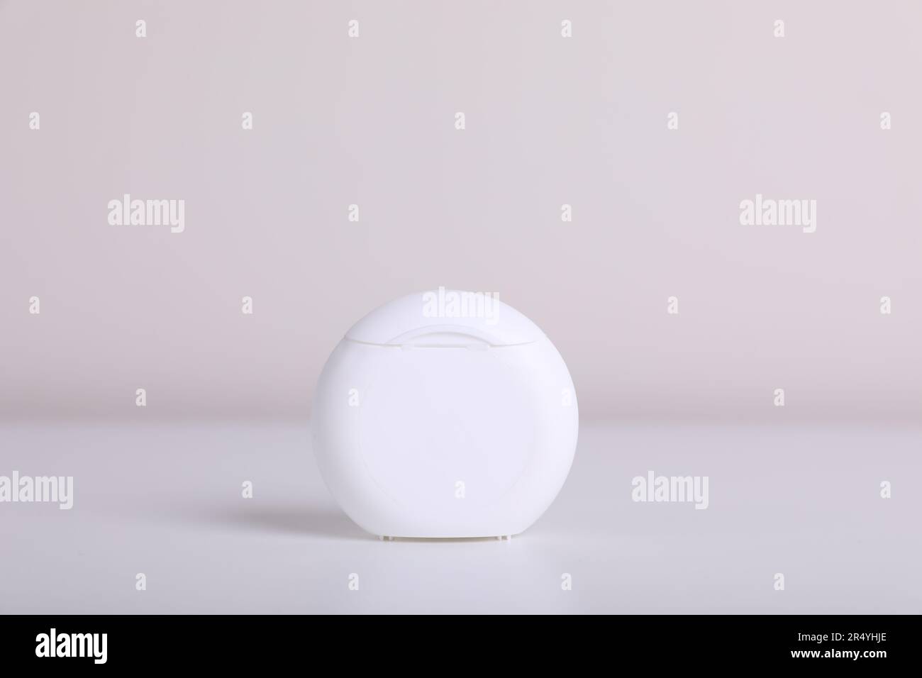 Container with dental floss on white background Stock Photo - Alamy