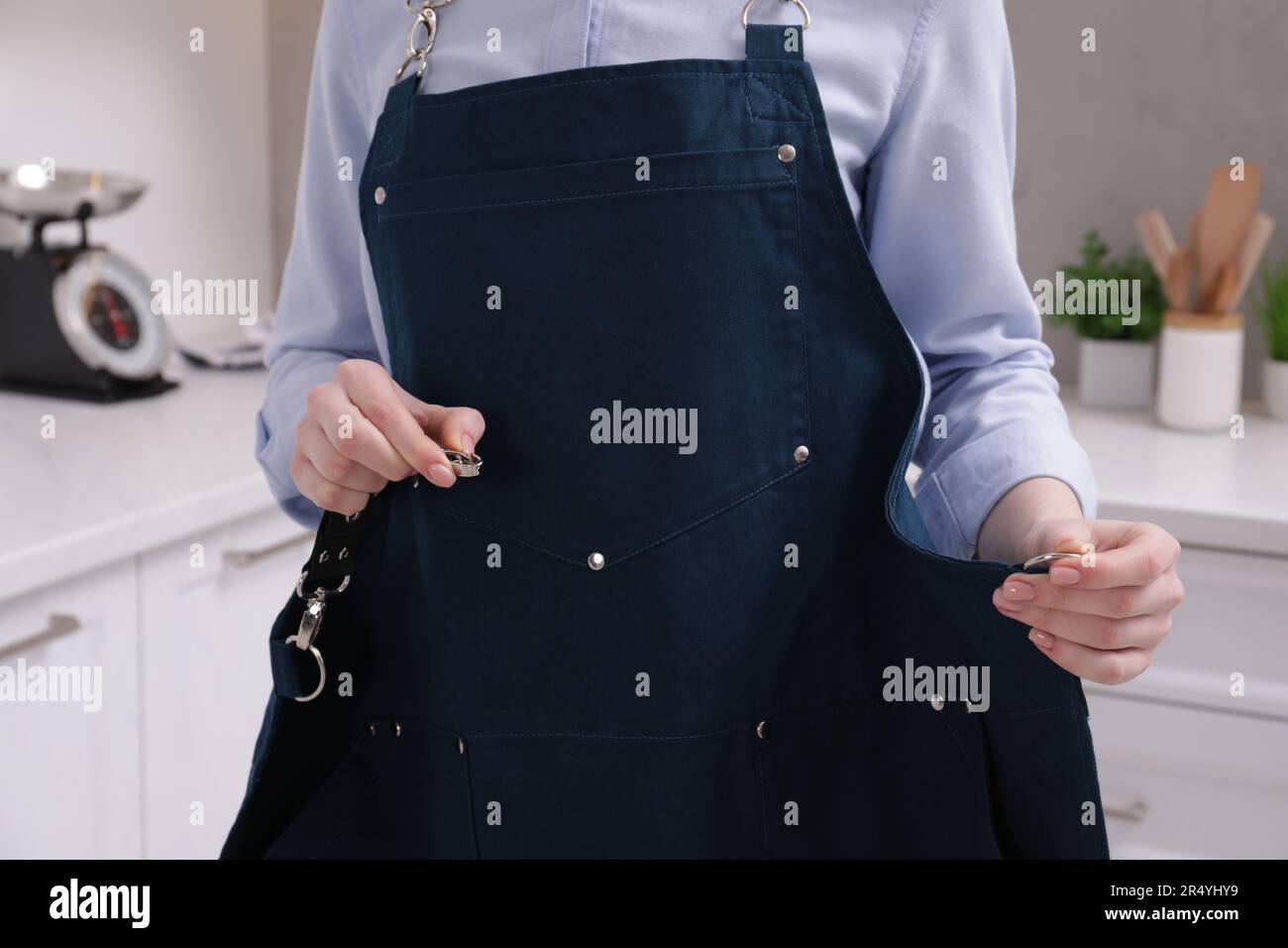 Woman putting apron on hi-res stock photography and images - Alamy