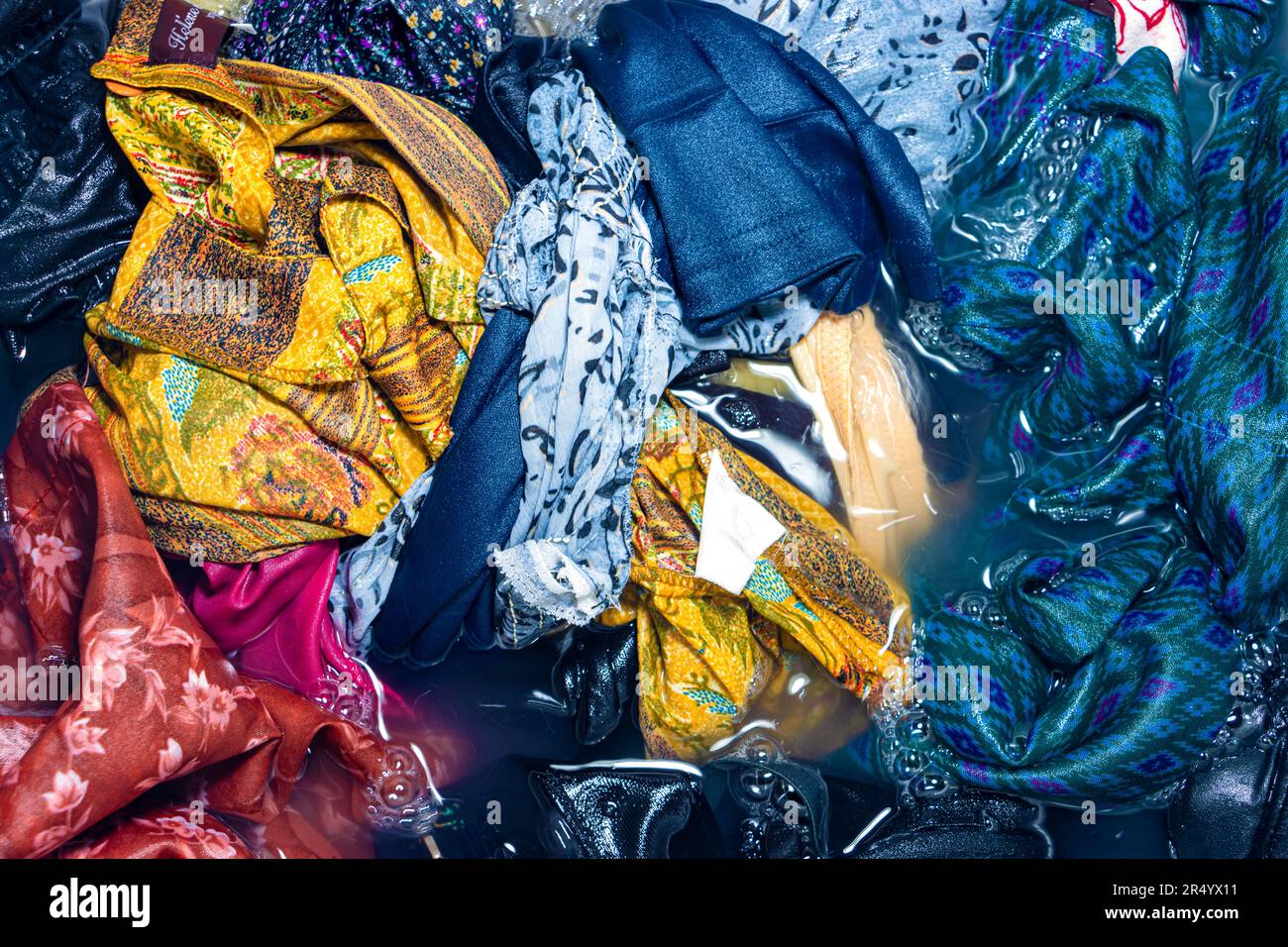 Laundry soaked in water is ready for washing procedure Stock Photo