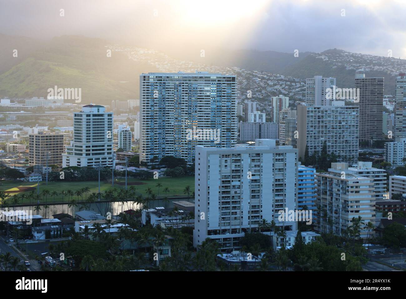 Shafts of golden light at sunrise pierce through the clouds