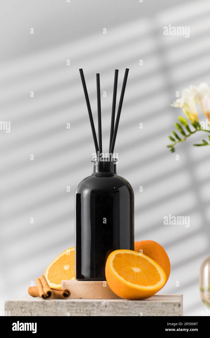 Black glass diffuser with the scent of cinnamon, orange. Perfumes for