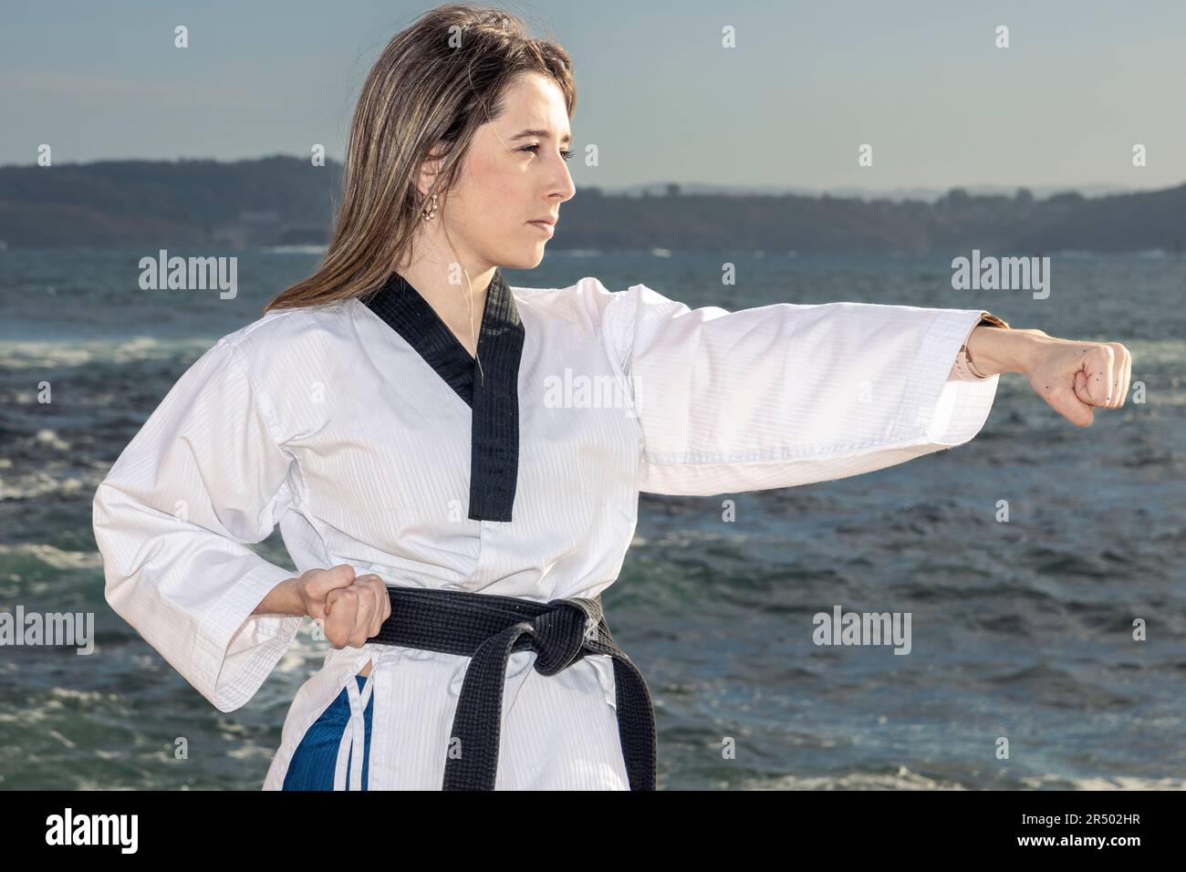Dynamic Serenity: Blonde Practitioner Engaging in Taekwondo Amidst the ...
