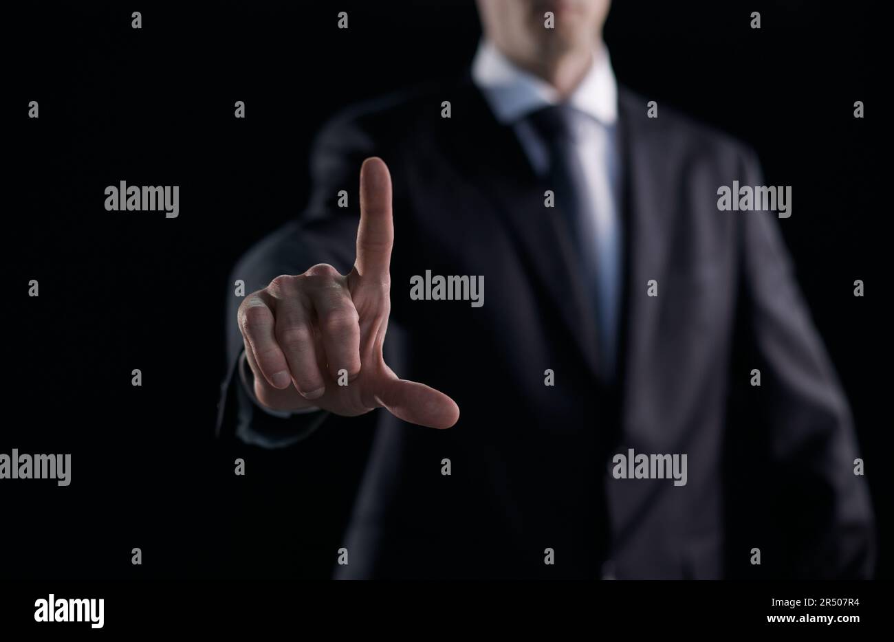 Business man pressing an imaginary button at his office. Stock Photo