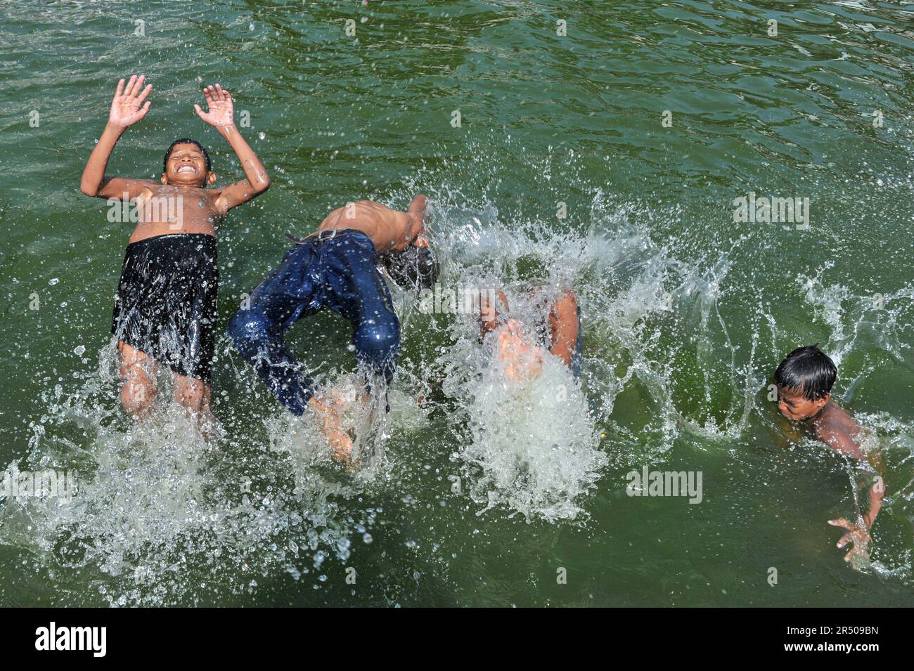 Sylhet, Bangladesh. 30th May 2023. Local children playing in a pond ...