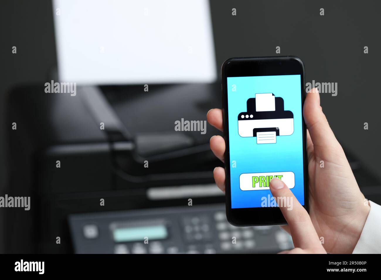 Man using printer management application on mobile phone indoors, closeup and space for text Stock Photo