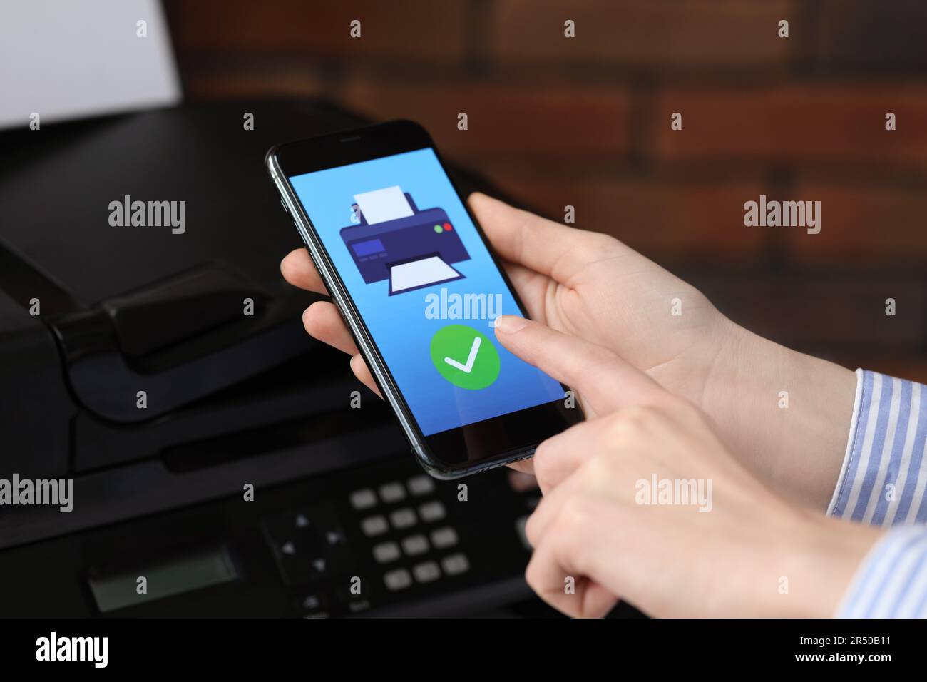 Man using printer management application on mobile phone indoors, closeup. Image on device screen. Stock Photo