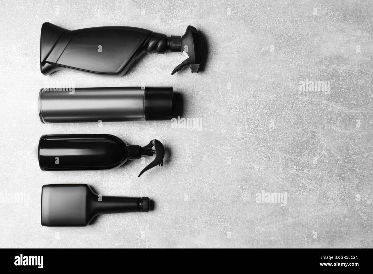 Flat lay composition with car cleaning products on light grey table ...