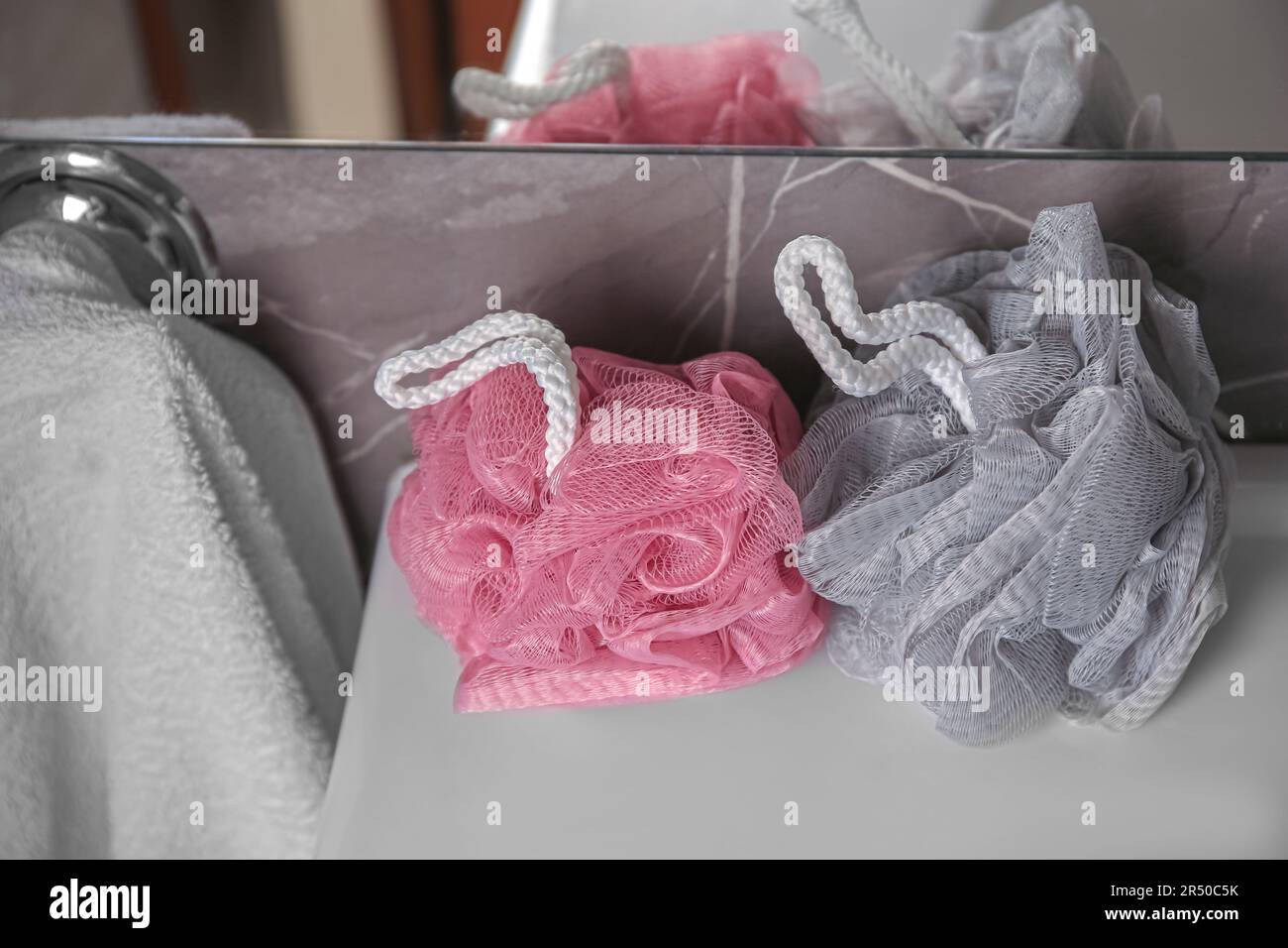 Colorful shower puffs on washbasin in bathroom Stock Photo Alamy