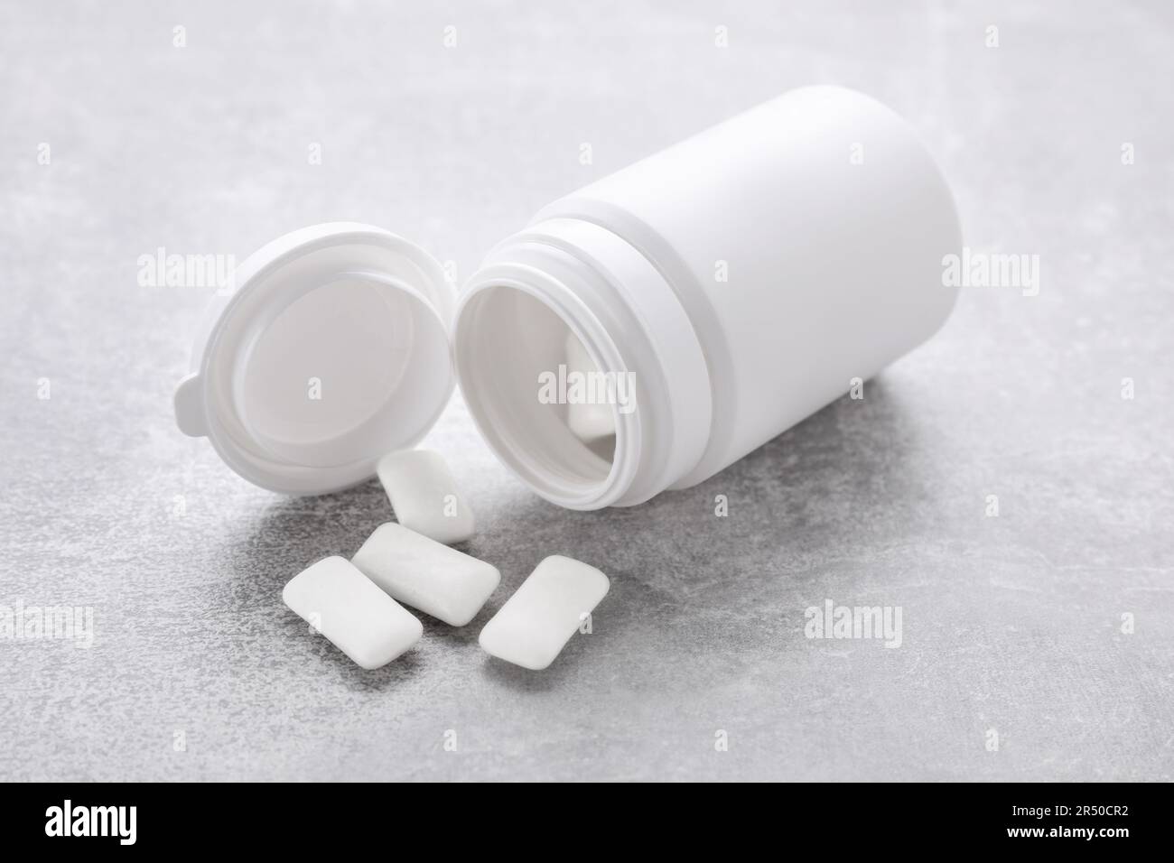 Jar with chewing gums on light grey table Stock Photo Alamy
