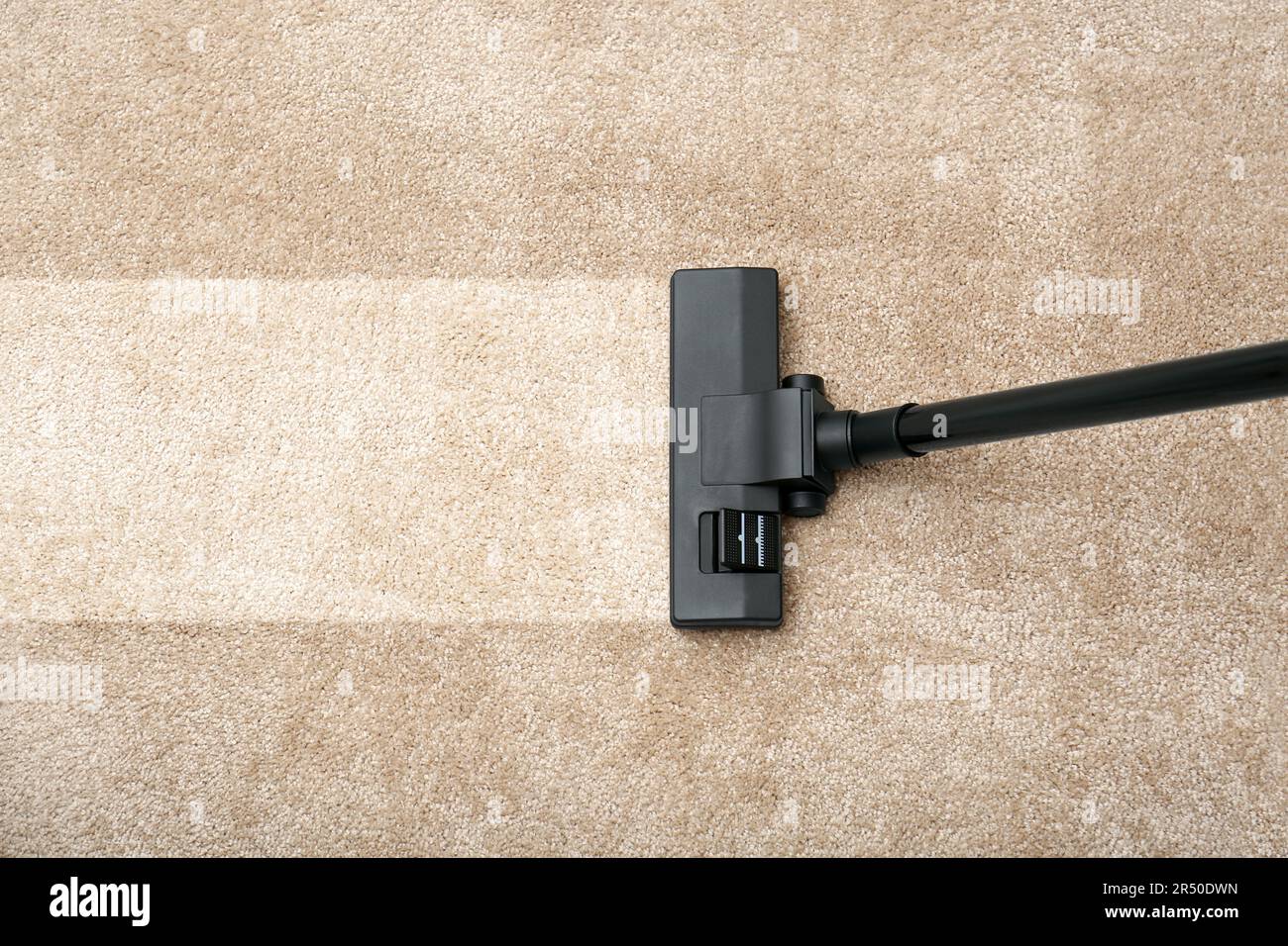 Vacuuming carpet. Clean area after using device Stock Photo Alamy