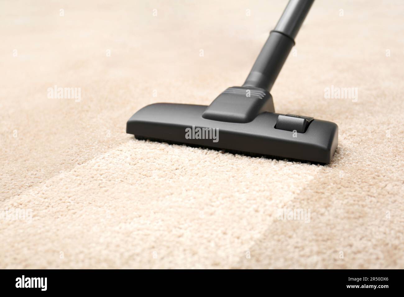 Vacuuming carpet. Clean area after using device, closeup Stock Photo