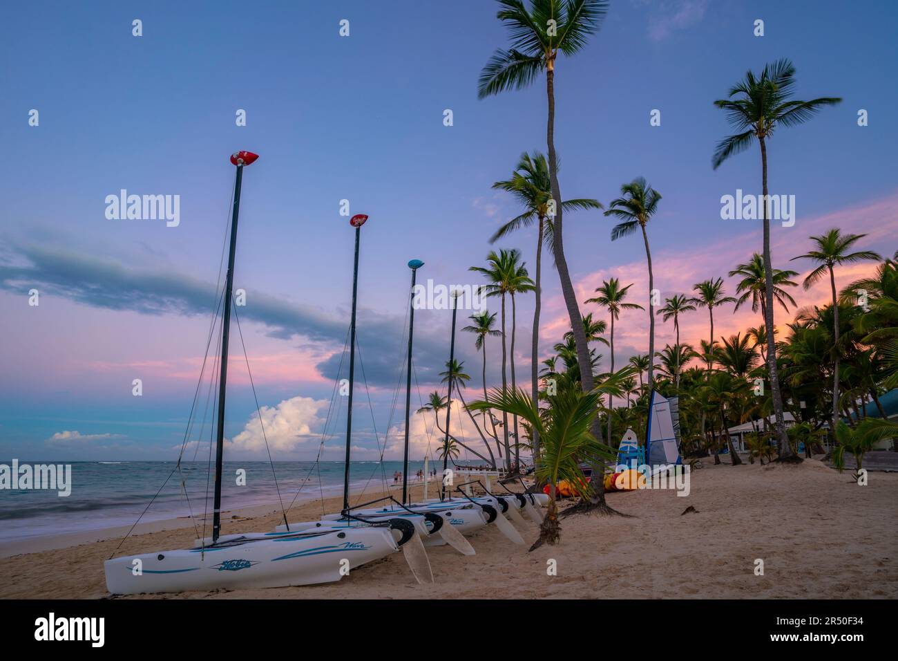 View of palm trees and sea at Bavaro Beach at sunset, Punta Cana, Dominican Republic, West Indies, Caribbean, Central America Stock Photo
