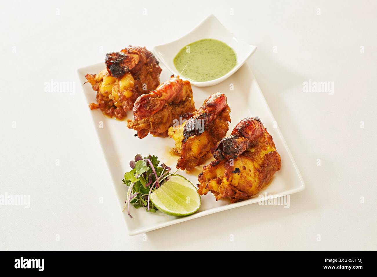 Indian prawns with a coriander dipping sauce Stock Photo Alamy