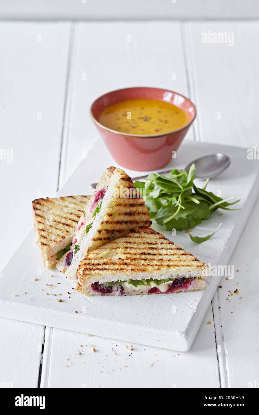 Grilled sandwiches with brie, cranberries and arugula Stock Photo