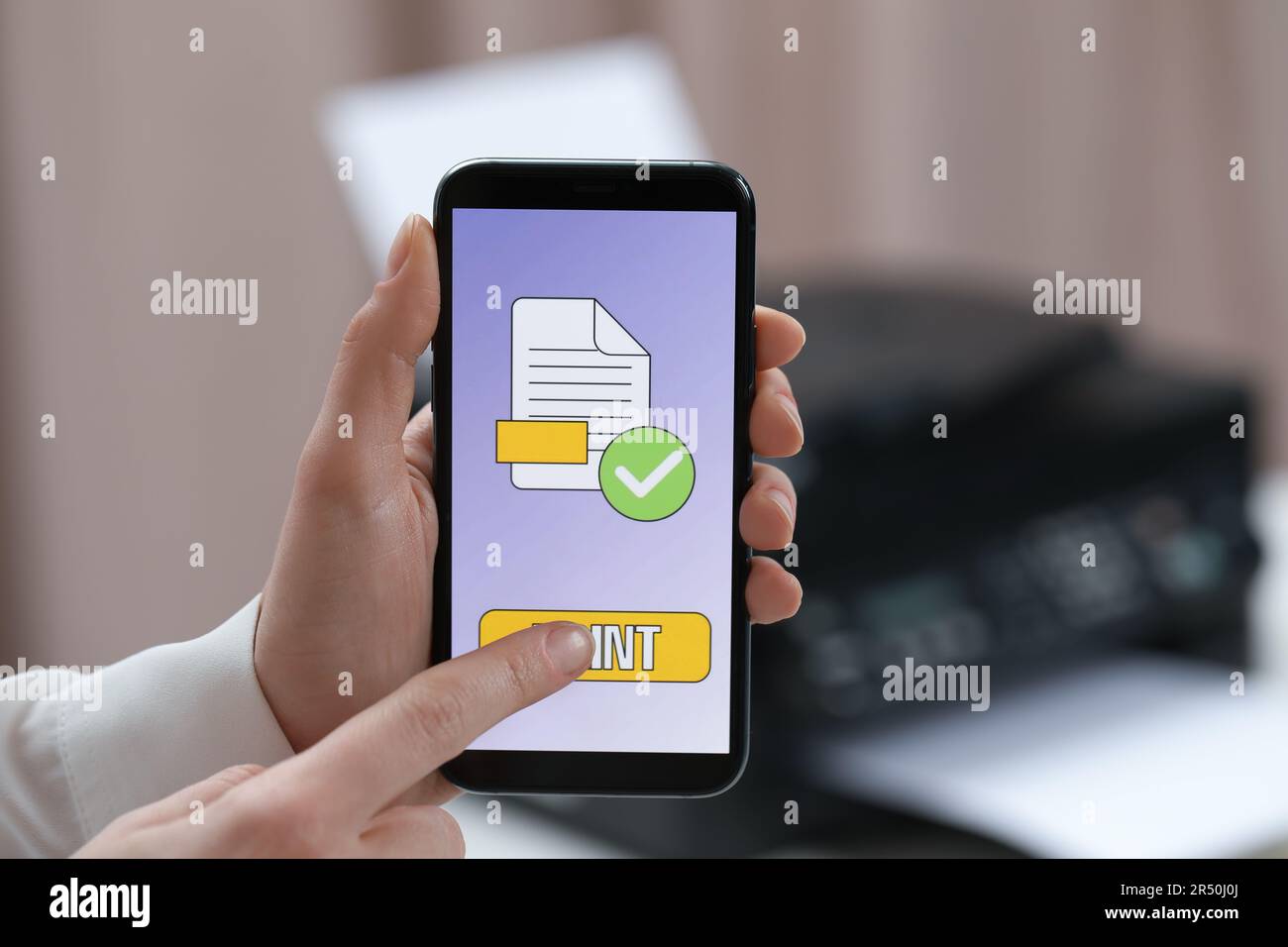 Man using printer management application on mobile phone in office, closeup Stock Photo