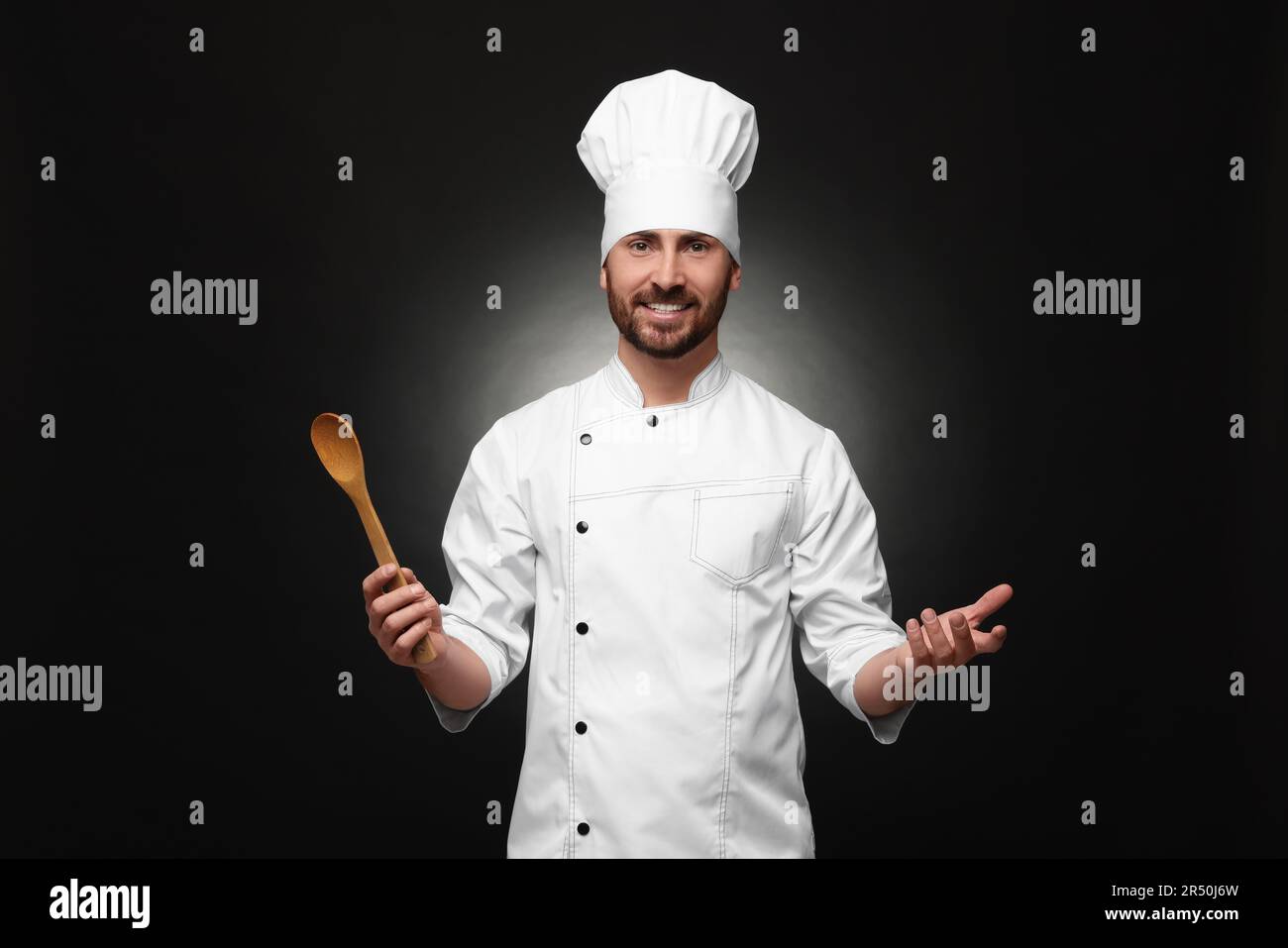 Chef Spoon Rocet Mature chef with spoon on black background Stock Photo - Alamy