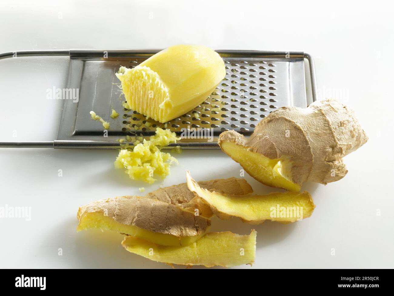 Ginger being grated Stock Photo Alamy
