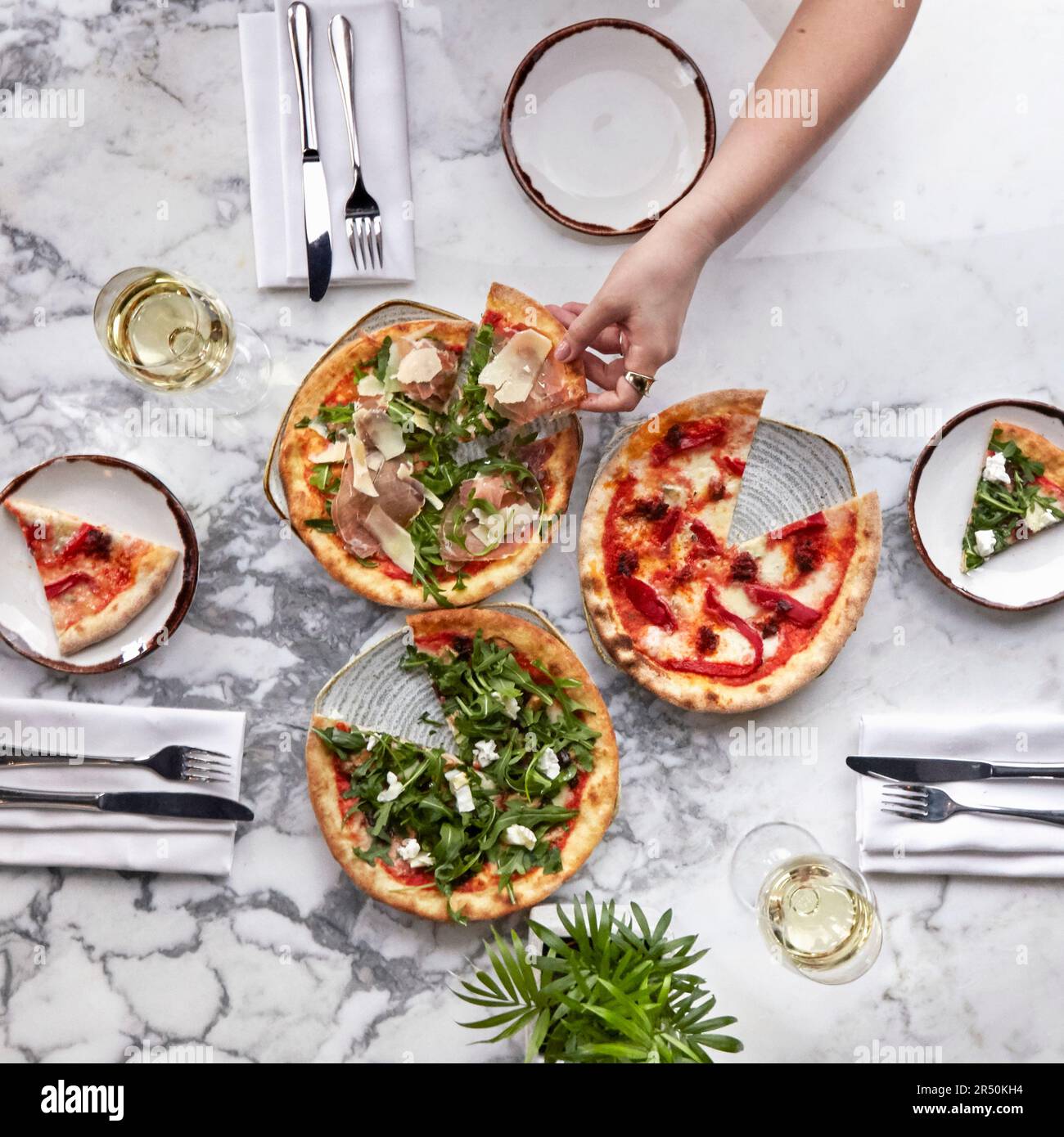 Different types of pizzas sliced on a marble table Stock Photo Alamy