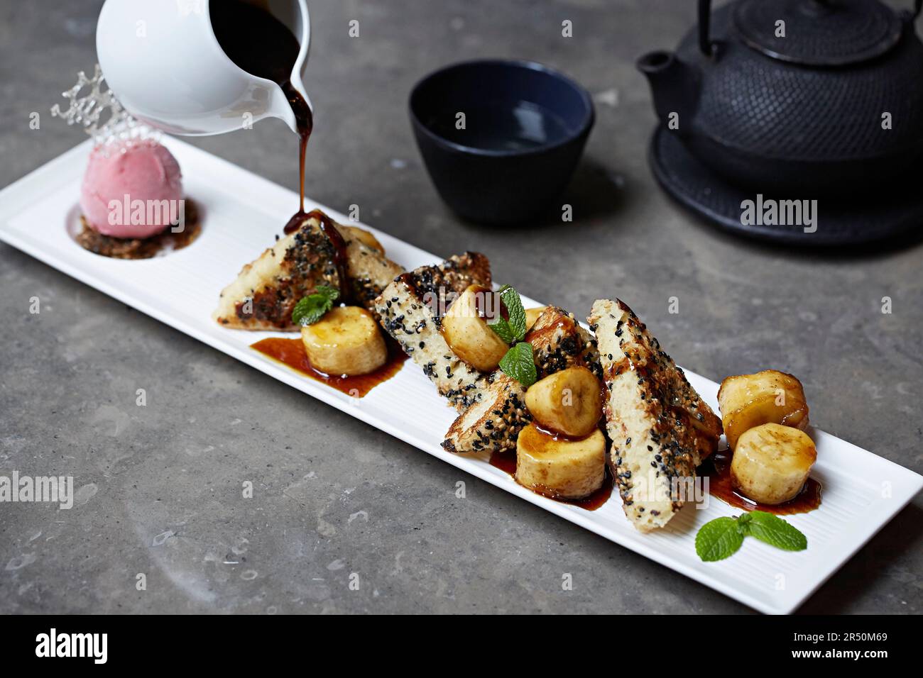 Japanese banana bread with banana slices and strawberry icecreamwith