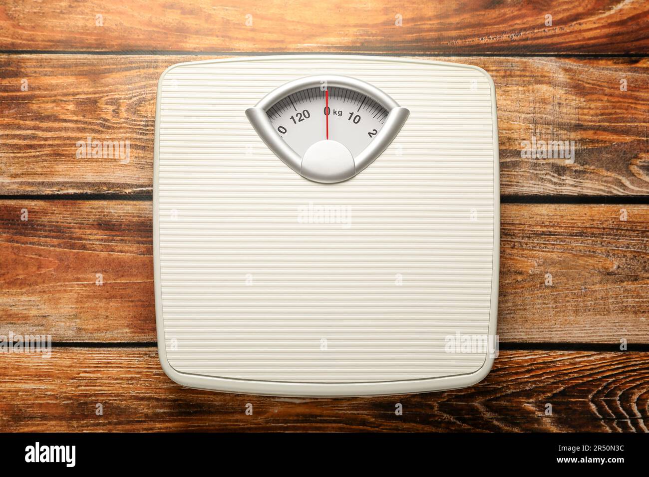 Weigh scales on wooden table, top view. Overweight concept Stock Photo