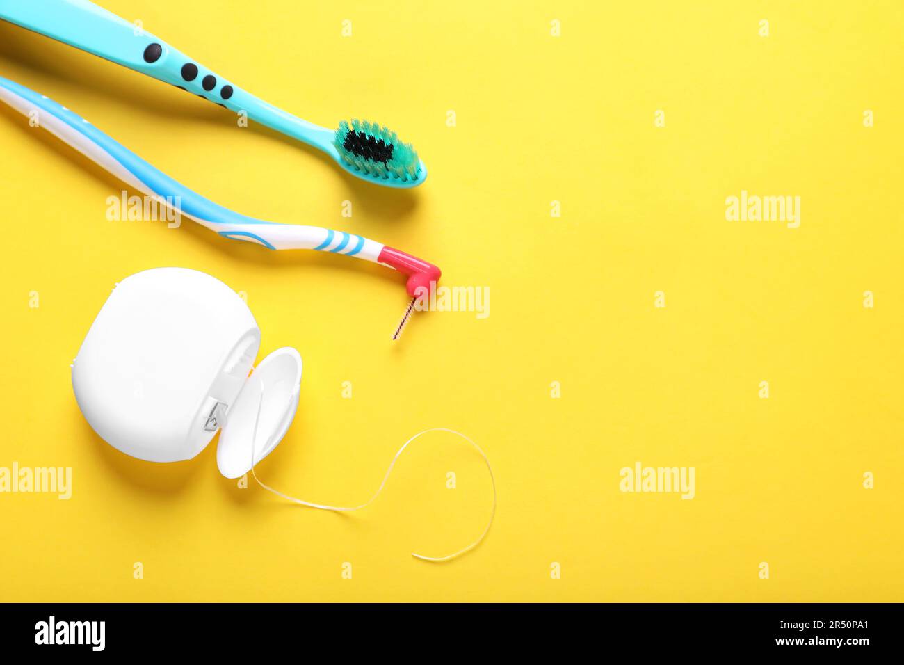 Container with dental floss and toothbrushes on yellow background, flat ...