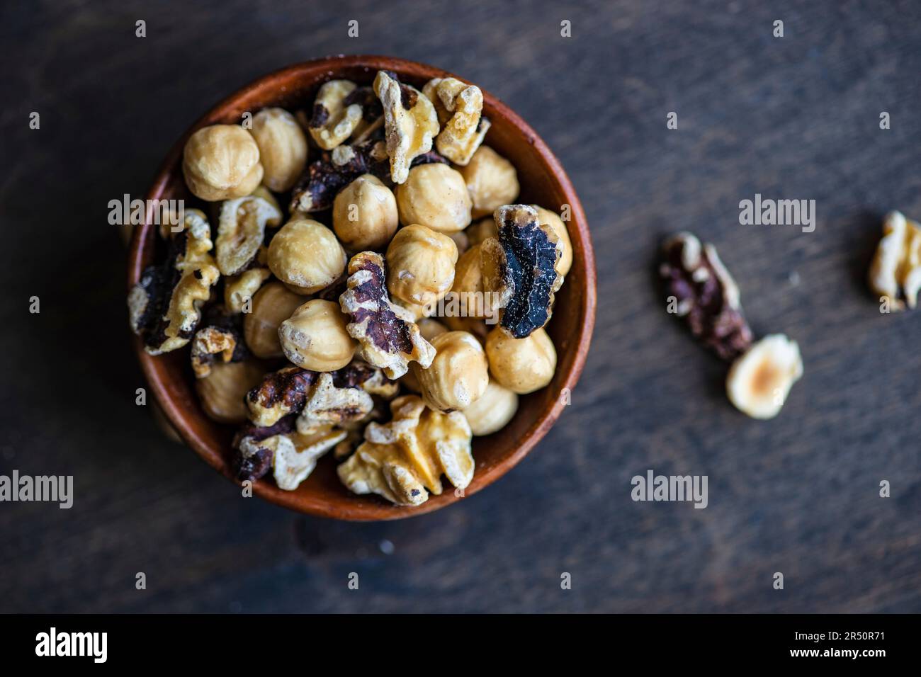 Mixed nuts in wooden bowl Stock Photo