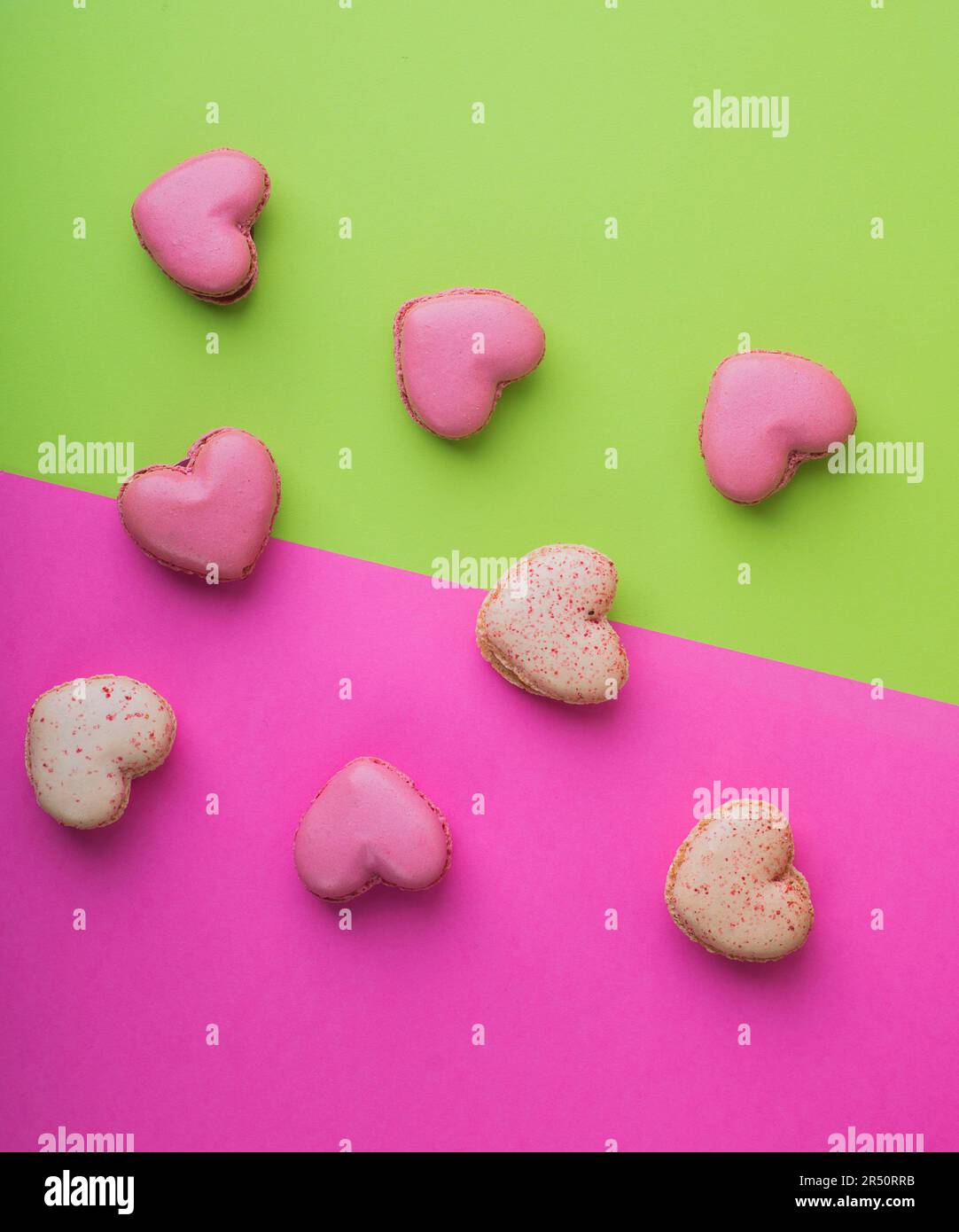 Heart-shaped macarons on a bright colored background Stock Photo