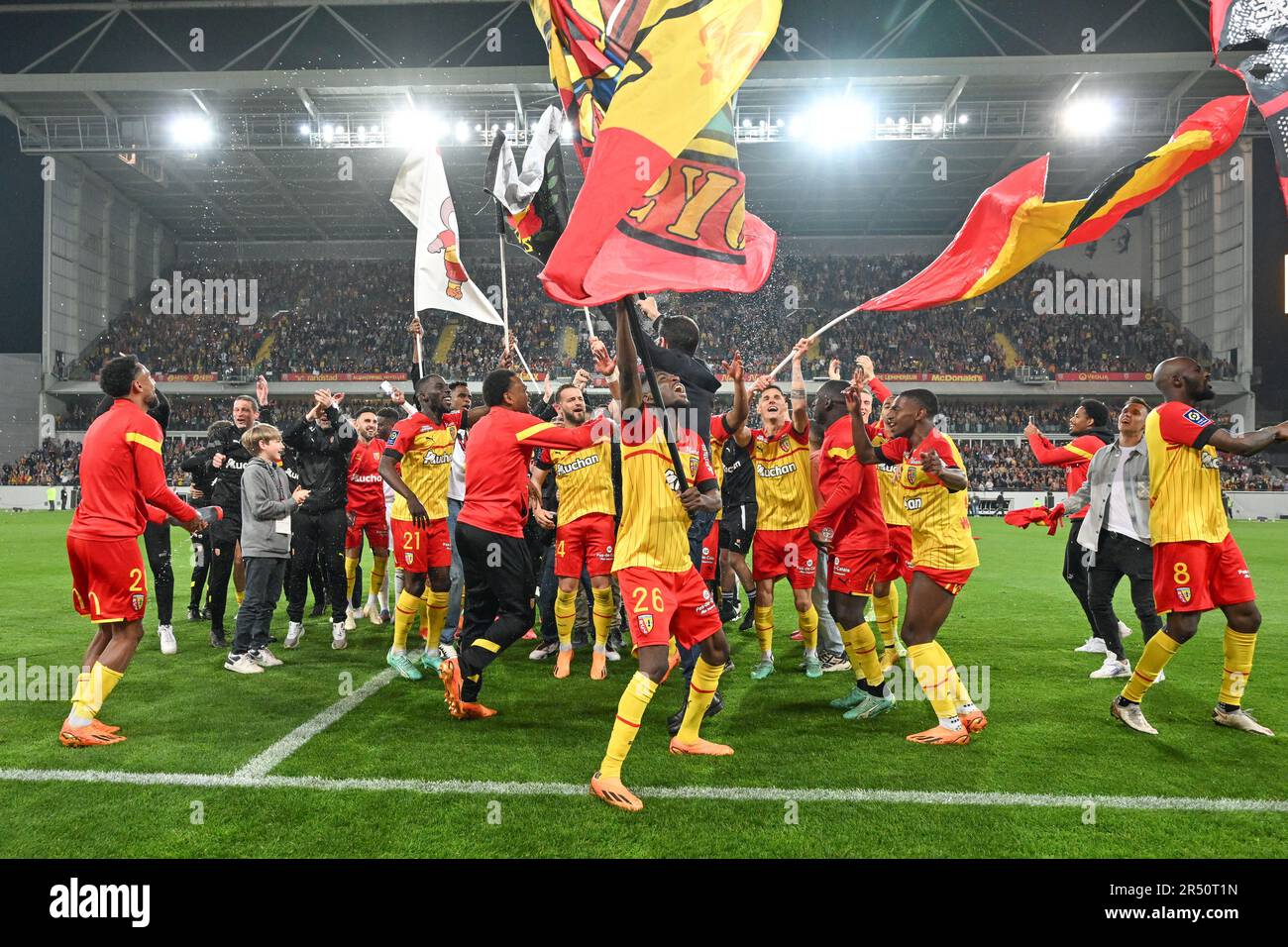 players of RC Lens and their president Joseph Oughourlian pictured  celebrating after winning and qualifying for the Champions League after a  soccer game between t Racing Club de Lens and AC Ajaccio