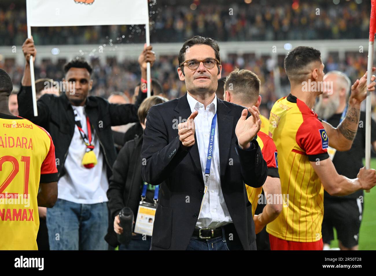 players of RC Lens and their president Joseph Oughourlian pictured  celebrating after winning and qualifying for the Champions League after a  soccer game between t Racing Club de Lens and AC Ajaccio