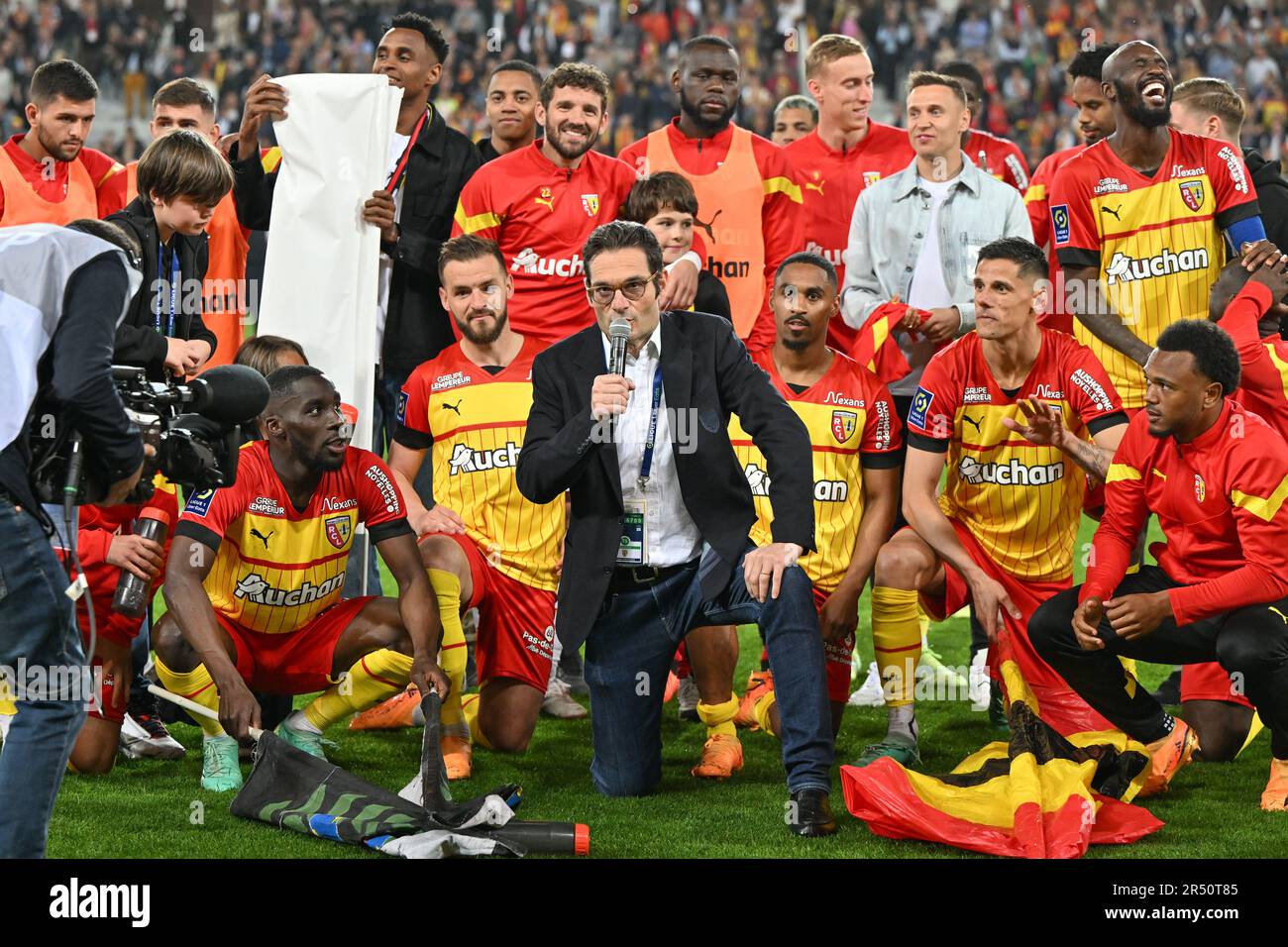 players of RC Lens and their president Joseph Oughourlian pictured  celebrating after winning and qualifying for the Champions League after a  soccer game between t Racing Club de Lens and AC Ajaccio