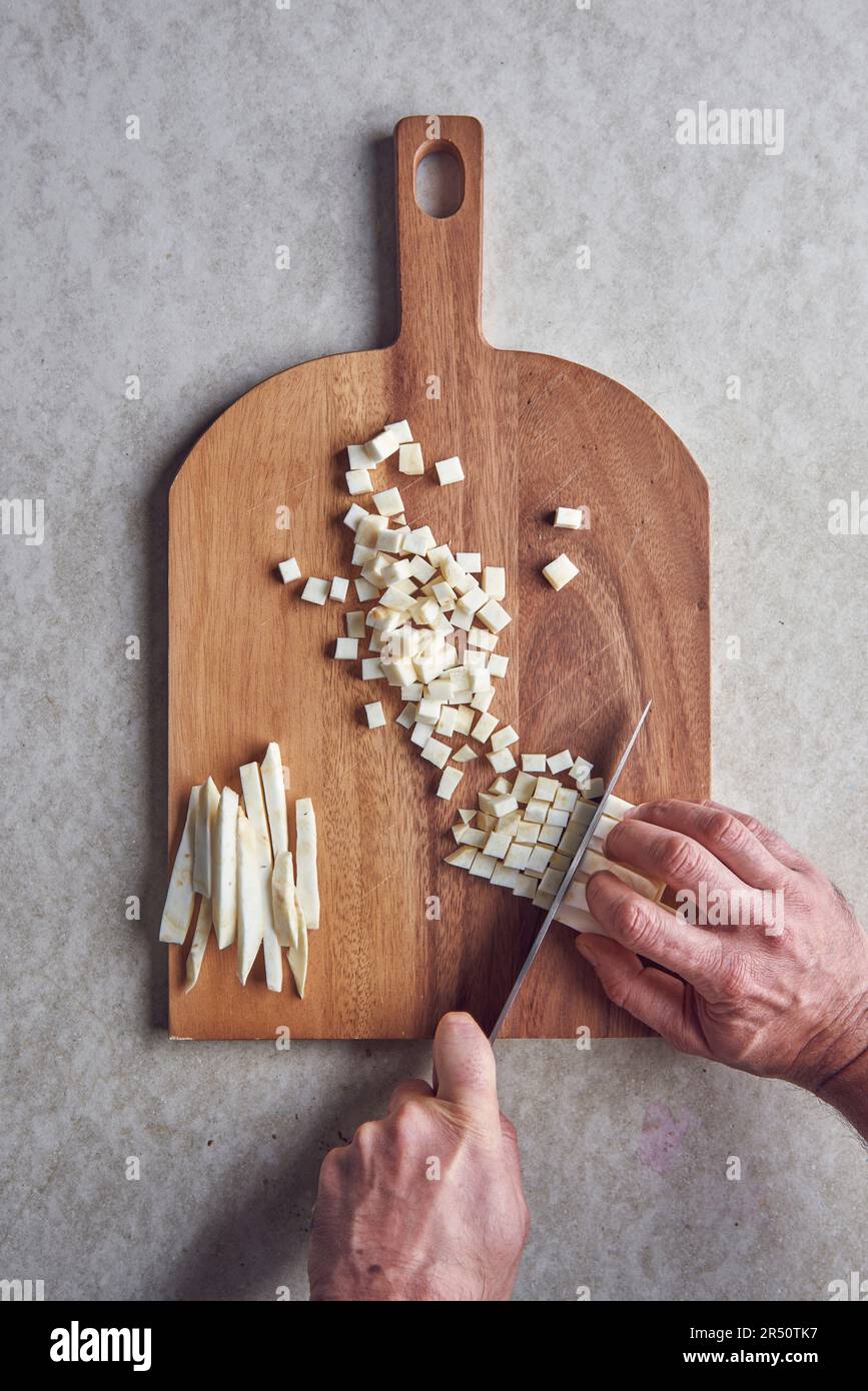 Celeriac being cut into small cubes Stock Photo Alamy