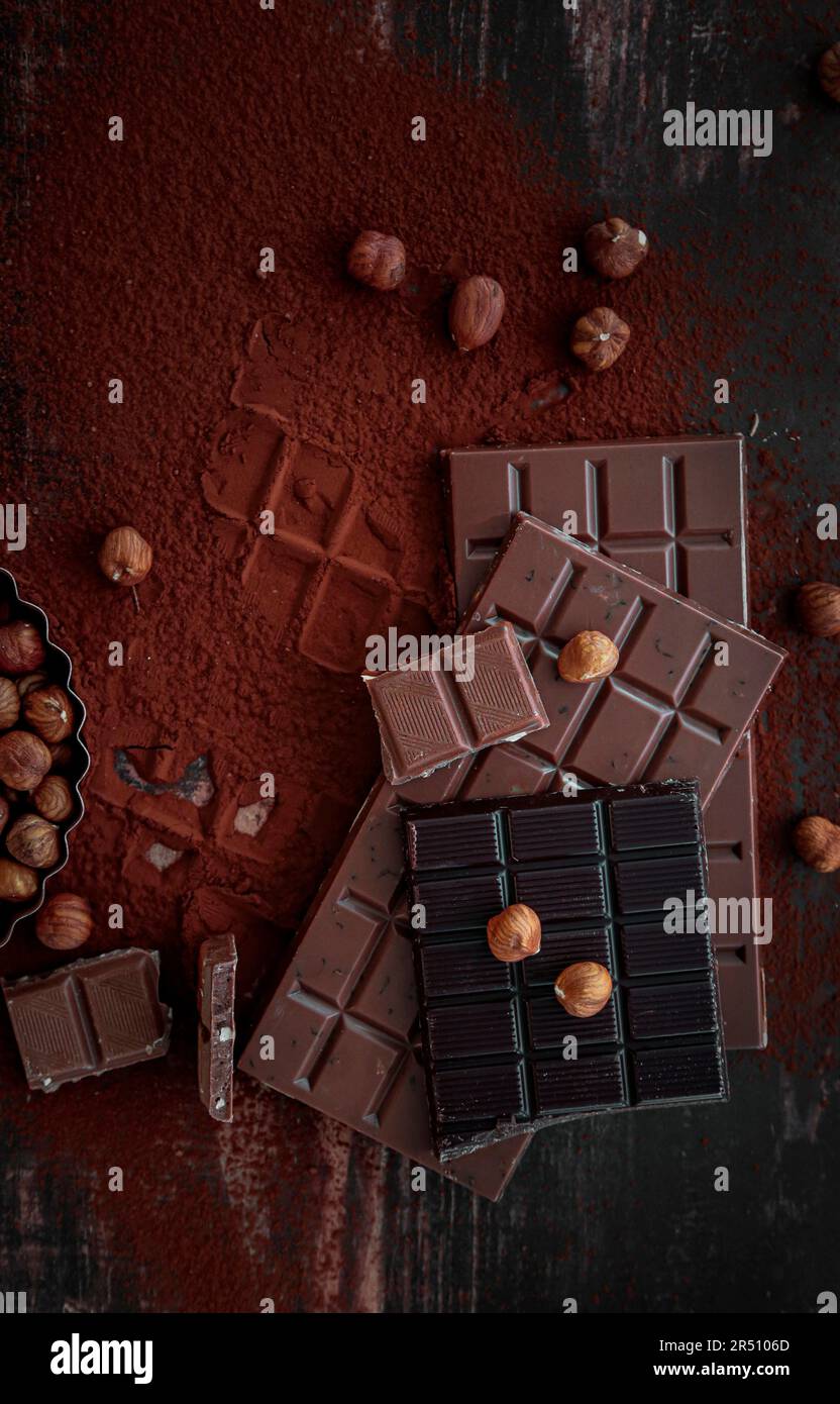 Assorted chocolate bars on cocoa powder Stock Photo