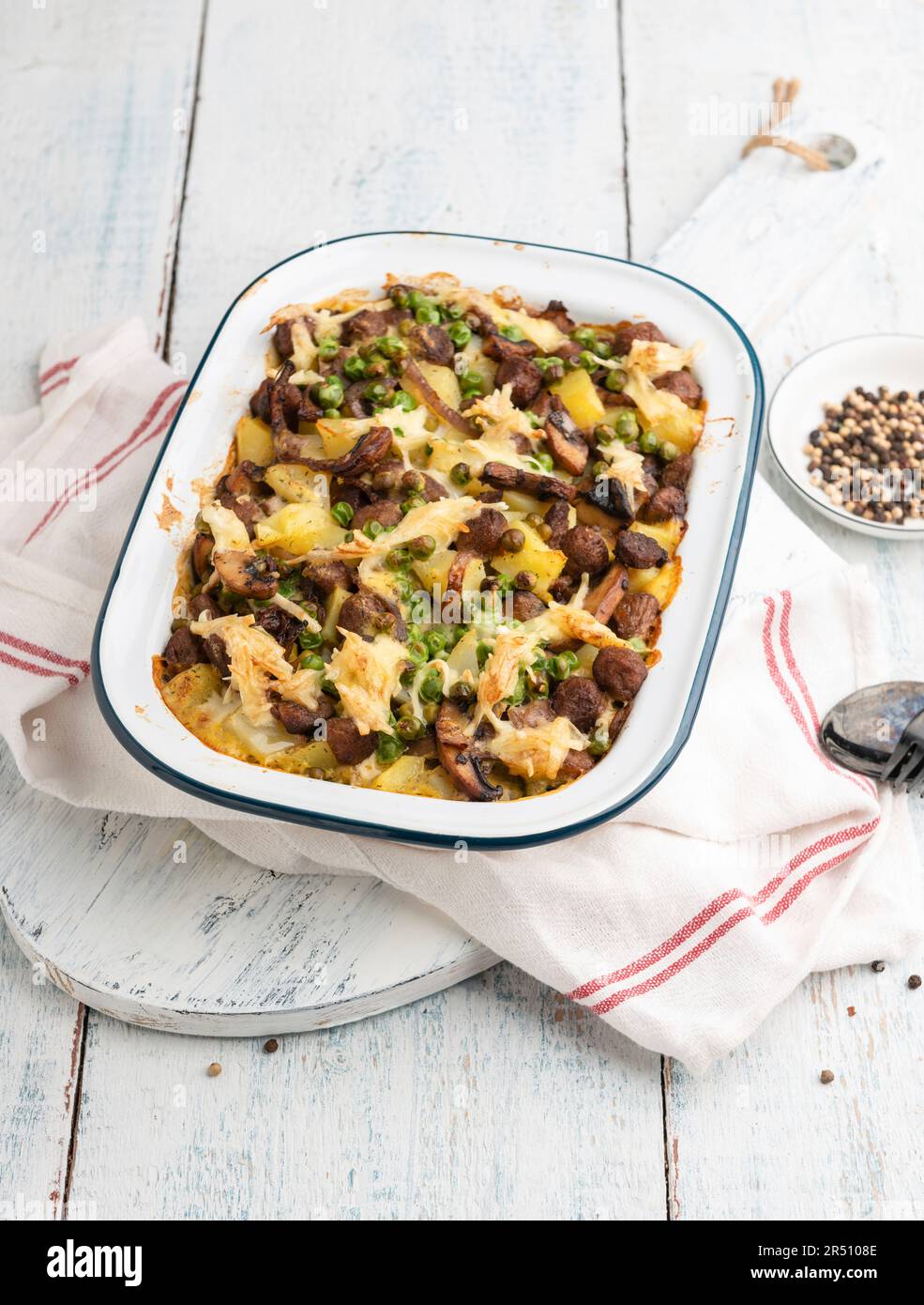 Vegan potato bake with peas and spicy soya chunks, topped with plant