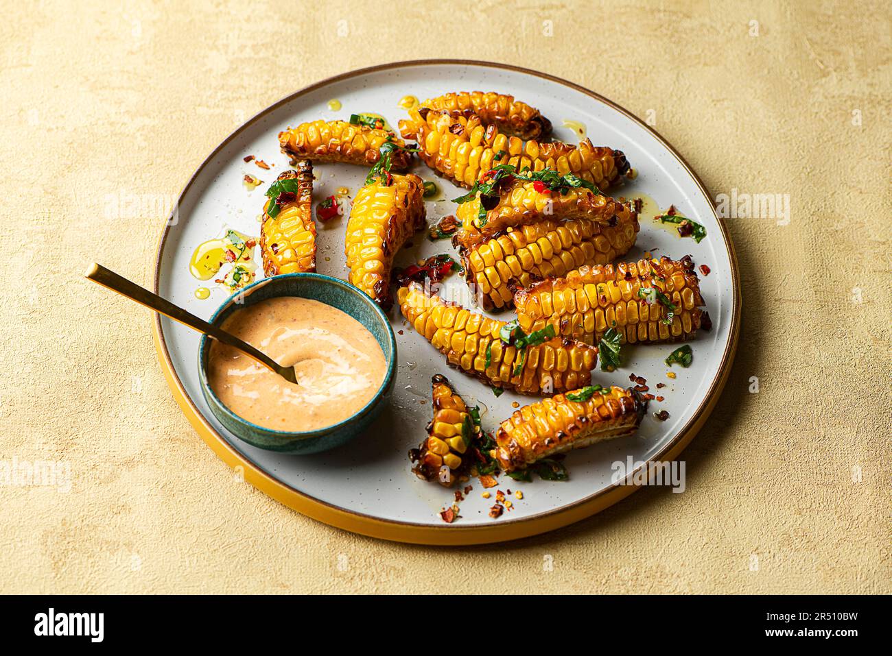 Corn ribs with chilli oil and siracha mayo Stock Photo