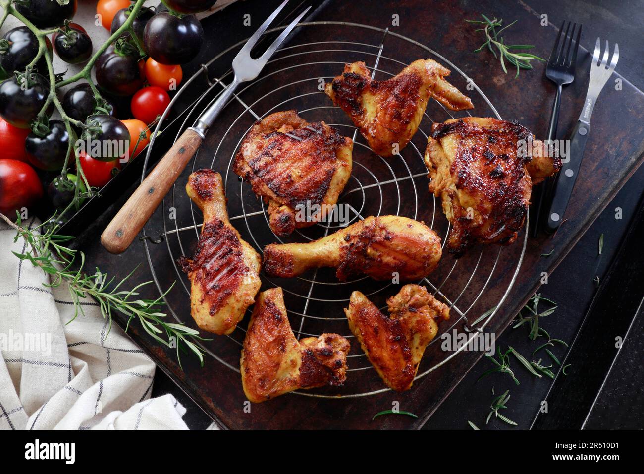 Grilled chicken drumsticks, thighs, and wings on a grill rack Stock