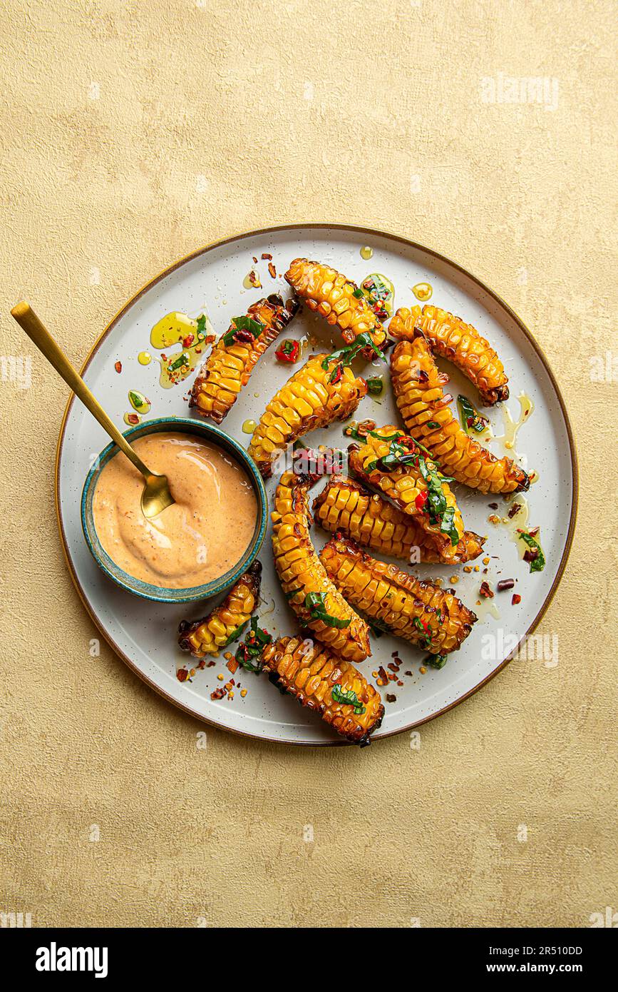 Corn ribs with chilli oil and siracha mayo Stock Photo