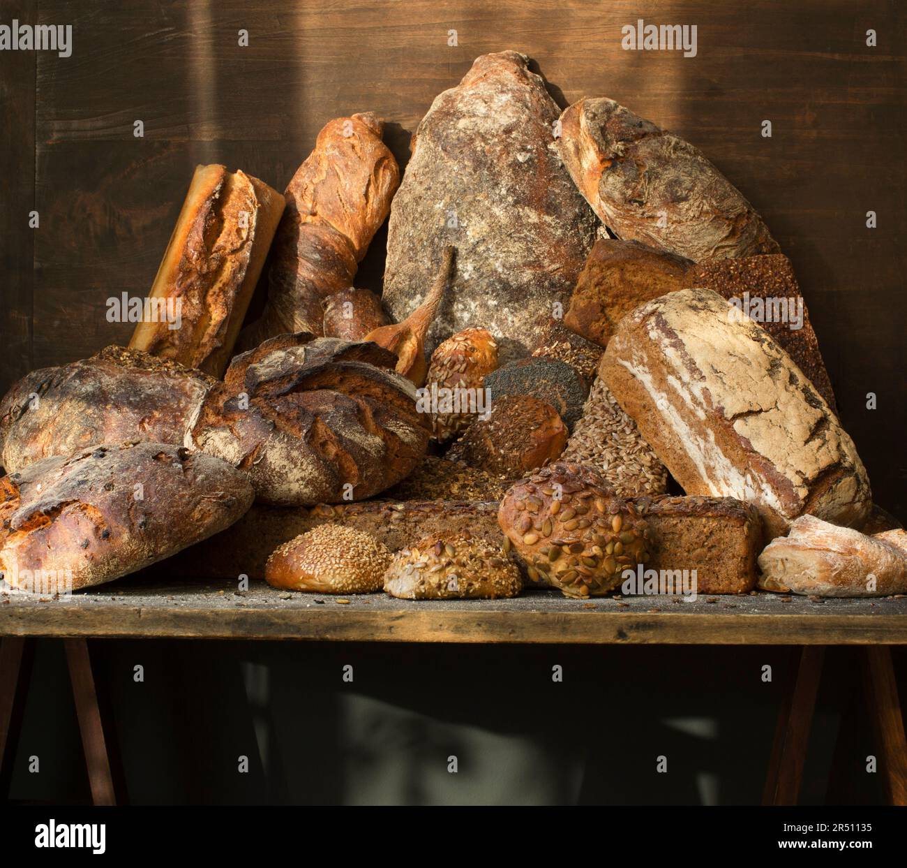 Various rustic breads on a wooden table Stock Photo